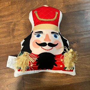 Festive Nutcracker Pillow with Red and Gold Accents
